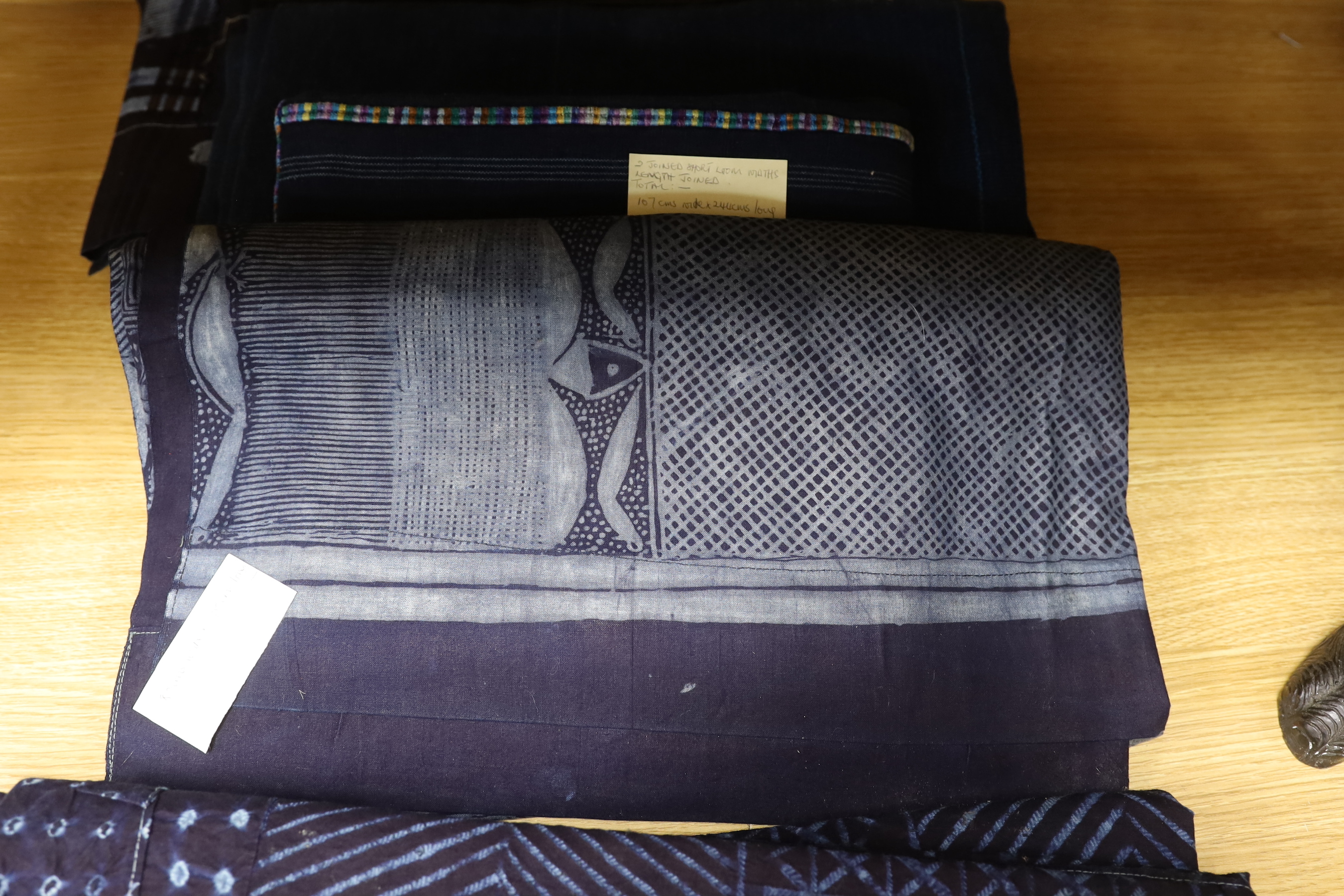 Four 20th century Nigerian Adire, indigo dyed, batik printed, cotton hangings, all with different designed motifs on short looms and two other short loom, woven indigo panels, largest cotton printed panel 180cm wide, 200